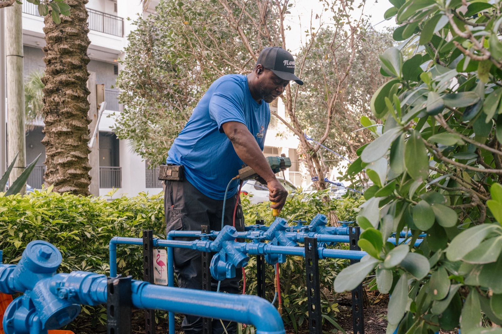 A Flamingo Plumbing technician working on a commercial backflow assembly