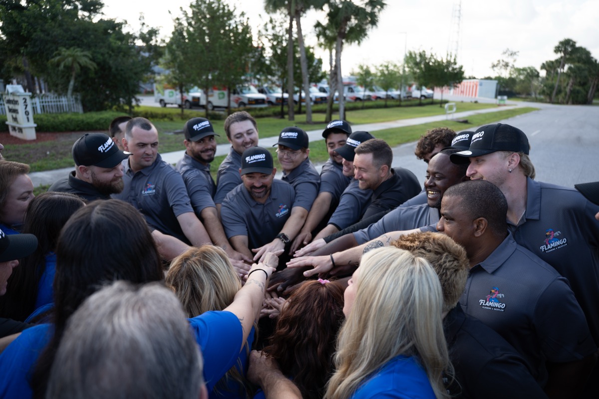 The team putting hands in together