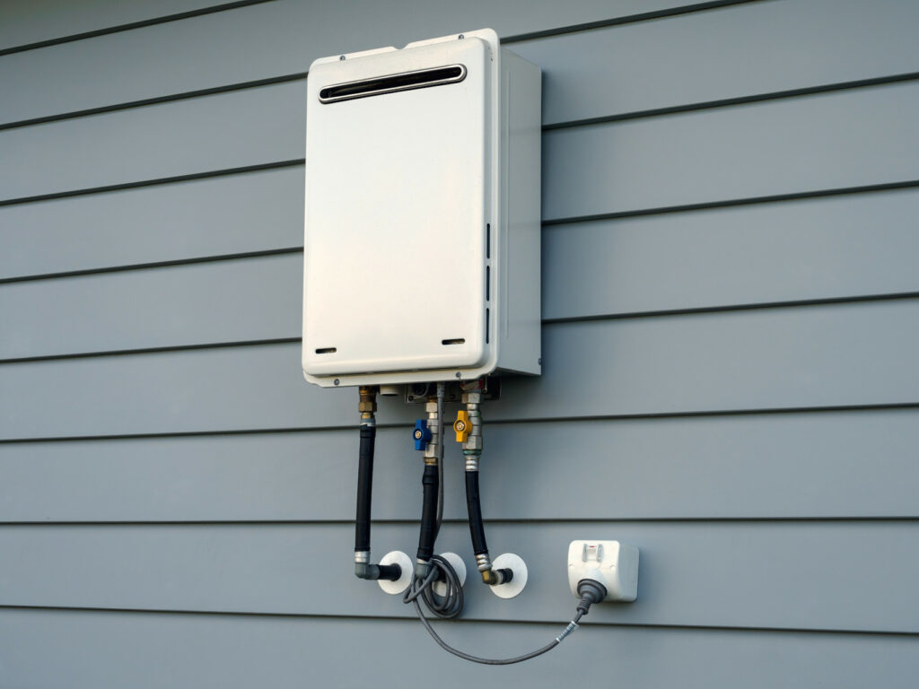 tankless water heater outside on a wall