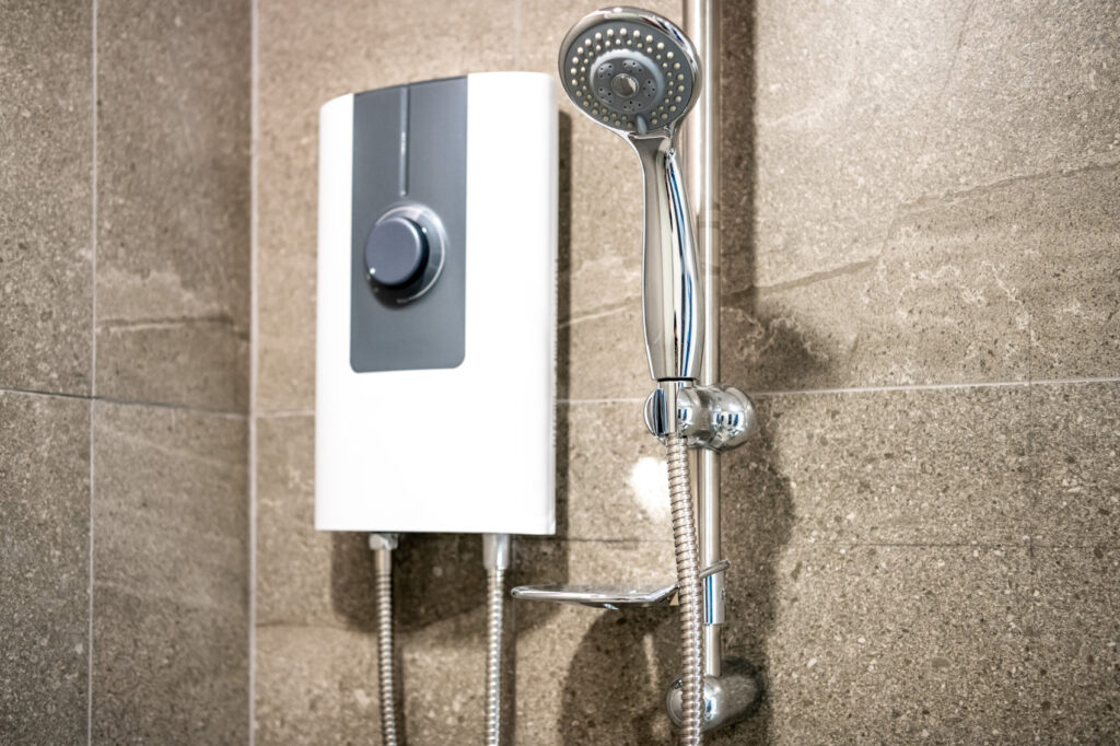 a tankless water heater on wall in shower